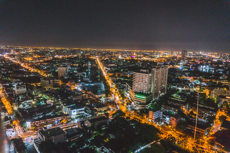 City lights glowing throughout Bangkok from a rooftop bar.