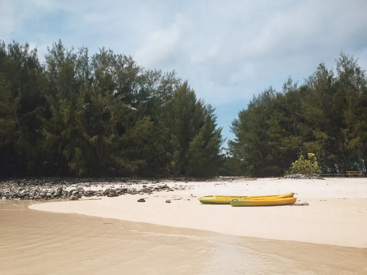 Kayaks on a motu beach in Rarotonga.